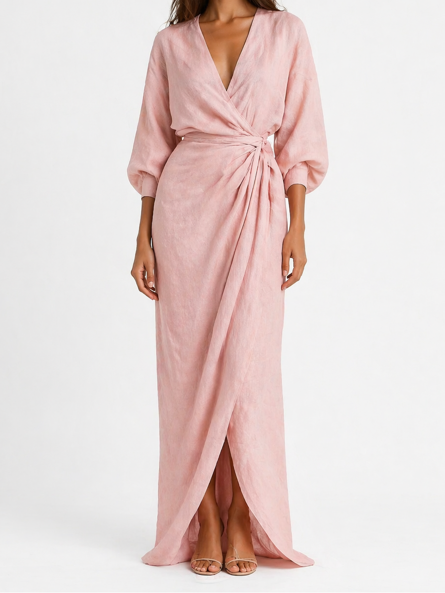 Woman wearing a pink wrap dress on a white background