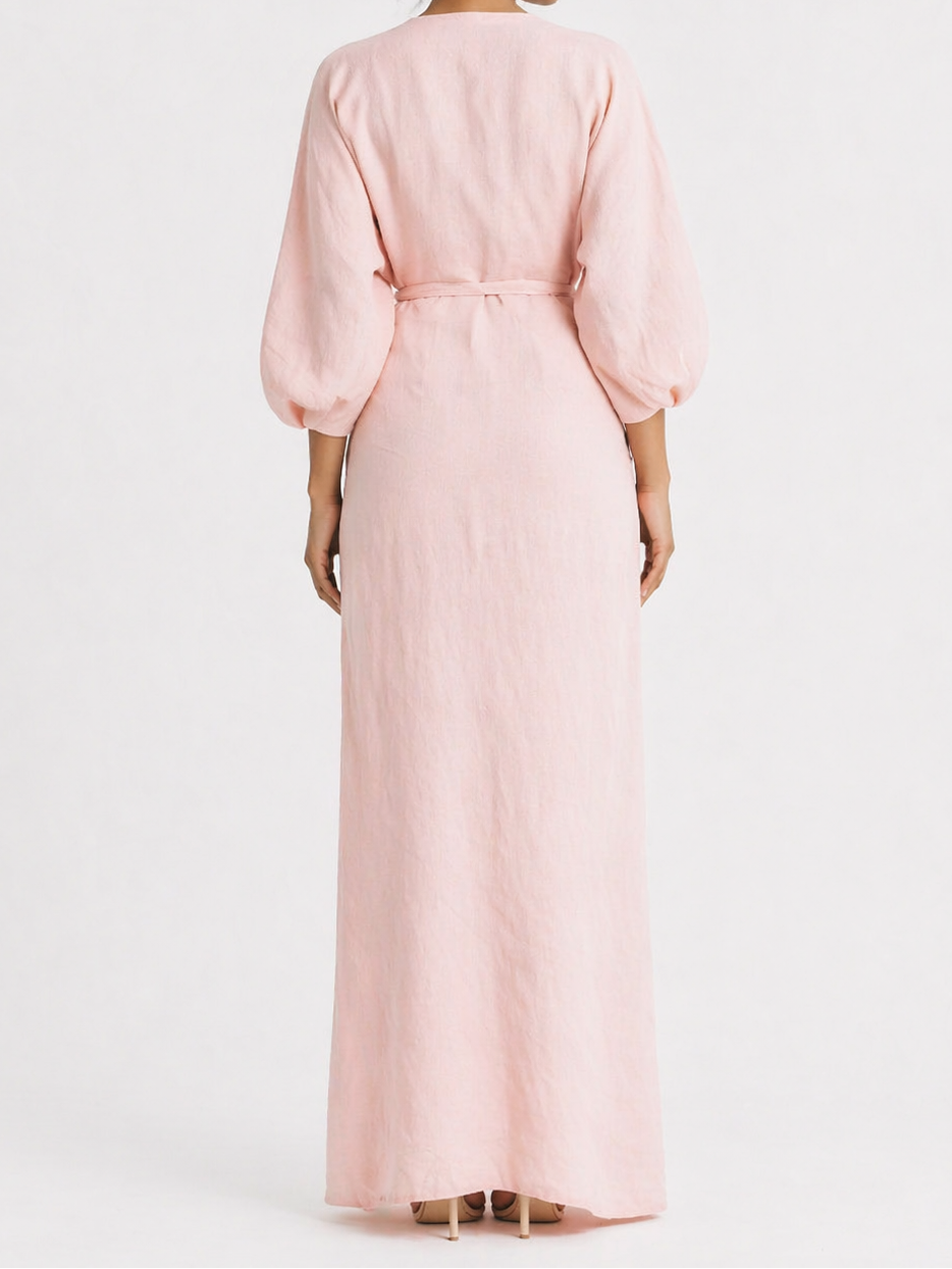 Woman wearing a pink dress against a white background