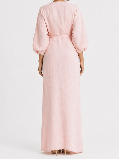 Woman wearing a pink dress against a white background